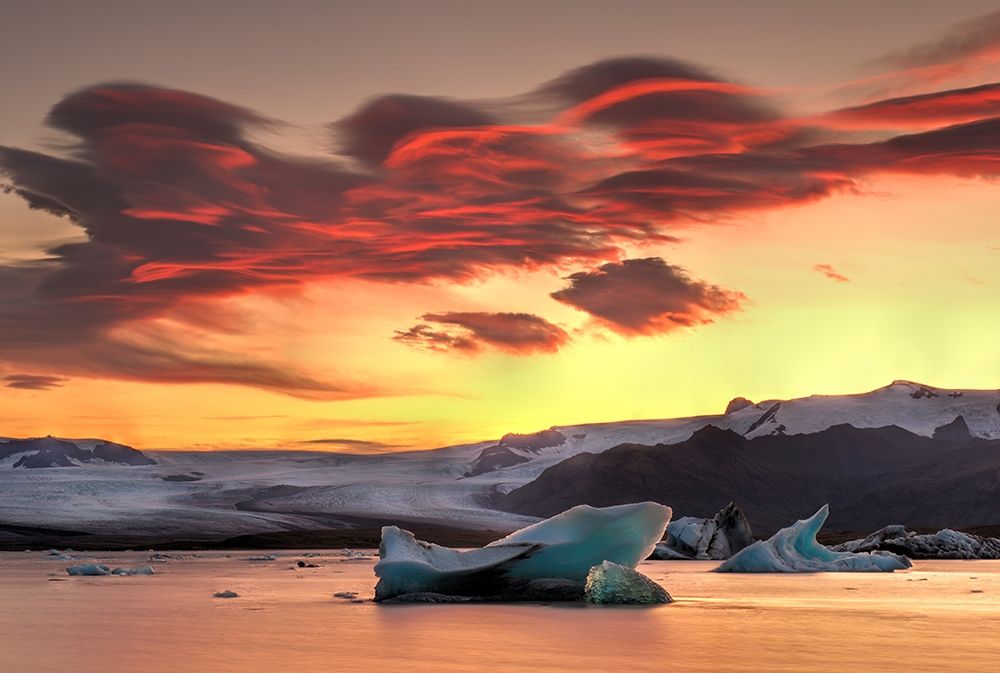 Icebergs from the Jokulsarlon glacier adrift in sunset in Jokulsarlon lagoon in Iceland art print by Steve Mohlenkamp for $57.95 CAD